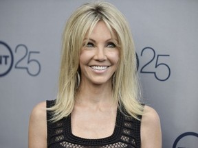 In a July 24, 2013 file photo, Heather Locklear arrives at the TNT 25th Anniversary Party at The Beverly Hilton Hotel in Los Angeles. Locklear has been charged with several counts of battery against first responders who answered a domestic violence call at her Southern California home. The 56-year-old "Melrose Place" actress was charged Monday, March 12, 2018, with four misdemeanor counts of battery on an officer or emergency personnel, and one misdemeanor count of resisting or obstructing an officer.