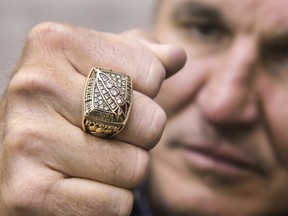 In this Monday, March 26, 2018 photo, former Super Bowl MVP Mark Rypien displays his Super Bowl ring in Spokane, Wash. Rypien said he has attempted suicide, hired prostitutes and suffers from persistent depression, and wonders if he suffered brain injuries while playing football. (Dan Pelle /The Spokesman-Review via AP)