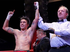 Steve Claggett, left, has bios armed raised as the winner over Giuseppe Lauri in boxing action at Cowboys in Calgary, Alberta, on Nov. 9, 2013. Claggett took the bout in a unanimous decision. Mike Drew/Calgary Sun/QMI AGENCY