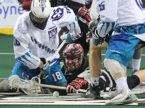 The Calgary Roughnecks Tyler Burton and Rochester Knighthawks players battle for control of the ball during NLL action at the Scotiabank Saddledome in Calgary on Saturday March 17, 2018.  Gavin Young/Postmedia