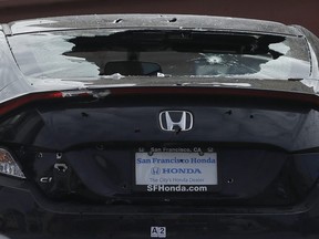 A shattered rear windshield appears on a vehicle as it is towed away in San Francisco, Wednesday, March 7, 2018.