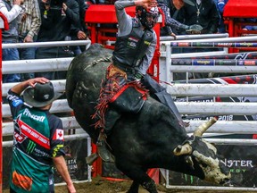 De Winton cowboy Brock Radford winning bull ride during the PBR Canada's Monster Energy event in the Nutrien Western Event Centre at Stampede Park in Calgary, Saturday, March 24, 2018. Al Charest/Postmedia