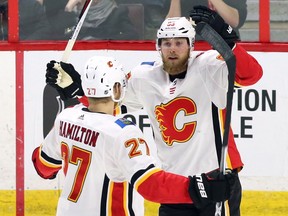 Calgary Flames centre Sam Bennett (93) celebrates his goal against the Ottawa Senators with defenceman Dougie Hamilton (27) during first period NHL hockey action in Ottawa on Friday, March 9 2018. THE CANADIAN PRESS/Fred Chartrand ORG XMIT: FXC104