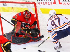 Calgary Flames goaltender Mike Smith makes a save on a shot by Connor McDavid during NHL hockey at the Scotiabank Saddledome in Calgary on Tuesday, March 13, 2018. Al Charest/Postmedia