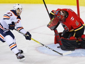 Calgary Flames goaltender Mike Smith makes a save on a shot by Connor McDavid during NHL hockey at the Scotiabank Saddledome in Calgary on Tuesday, March 13, 2018. Al Charest/Postmedia