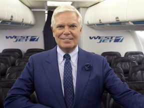 WestJet Airlines President & CEO Gregg Saretsky stands in the cabin of a Boeing 737 jet after the company's annual general meeting in Calgary on May 2, 2017. WestJet Airlines Ltd. says chief executive Gregg Saretsky is retiring effective today.