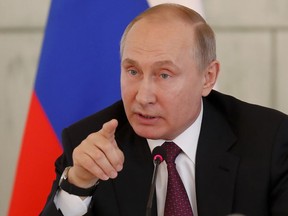 Russian President Vladimir Putin gestures while speaking to employees of the Almazov National Medical Center in St.Petersburg, Russia, Friday, March 16, 2018. (Anatoly Maltsev/Pool Photo via AP)