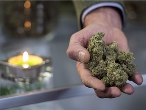 Marc Emery, who owns the Cannabis Culture brand with his wife Jodie, holds a handful of cannabis at the opening of one of their stores Thursday, December 15, 2016, in Montreal.