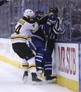 Boston Bruins defenceman Adam McQuaid sandwiches Leafs’ Roman Polak and a referee into the boards during Game 6 last night at the Air Canada Centre. (JACK BOLAND/Toronto Sun)