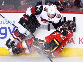 Arizona Coyotes' Trevor Murphy (left) runs into Calgary Flames' Garnet Hathaway on Tuesday, April 3, 2018.