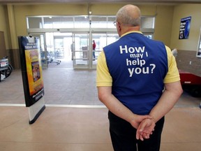 A Walmart greeter waits to welcome new customers on May 17, 2006 in Bowling Green, Ohio.