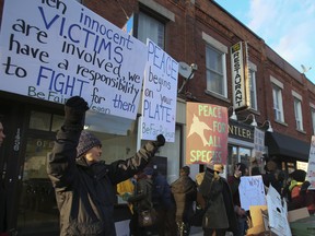 Protesters gather in front of Antler Restaurant on Dundas St. W. in Toronto, Ont., on Thursday, April 5, 2018. (VERONICA HENRI/TORONTO SUN)