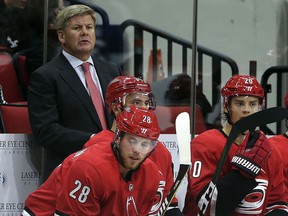 In this photo taken Wednesday, Sept. 20, 2017, Carolina Hurricanes coach Bill Peters watches his team against the Tampa Bay Lightning in Raleigh, N.C. (AP Photo/Gerry Broome)