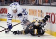 Maple Leafs forward Connor Brown vies for the puck with Bruins defenceman Torey Krug on Saturday night in Boston. (The Associated Press)