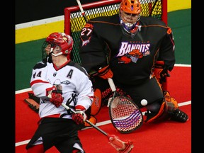 The Calgary Roughnecks' Wesley Berg backhands a shot on Buffalo Bandits goaltender Alex Buque during a National Lacrosse League game in Calgary on Saturday April 14, 2018.