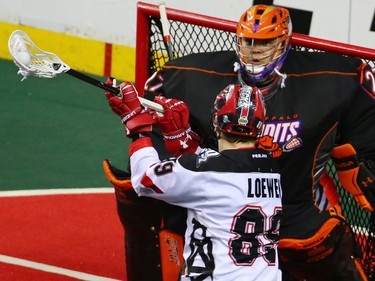 The Calgary Roughnecks' Riley Loewen lines up a shot on Buffalo Bandits goaltender Alex Buque during a National Lacrosse League game in Calgary on Saturday April 14, 2018.