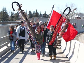 Students from Connect Charter School walk with Tsuut'ina students on 37 St SW over Glenmore Tr in Calgary Thursday, April 19, 2018. As part of an education partnership, about 1,000 students from Tsuut'ina schools and the Connect Charter Schools walked together to MRU for a pow wow. Jim Wells/Postmedia