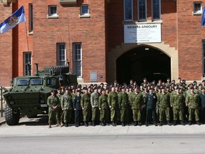 Members of the King's Own Calgary Regiment pose with two newly delivered Tactical Armoured Patrol Vehicles which were on display in front of Mewata Armoury in downtown Calgary on Sunday, April 22, 2018. The Regiment was celebrating the St. George's Day Parade in the Armoury. Jim Wells/Postmedia