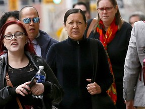 Elmarie Simons (centre) walks into Calgary Courts to be sentenced for criminal negligence in the 2015 death of 18-month-old girl Ceira McGrath.