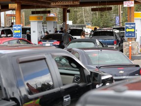 Hundreds came out for cheap gas to the Bragg Creek Shell as the owners put regular gas on for 32 cents, the amount of years they've owned the place, on their last day of business on Monday April 30, 2018. Darren Makowichuk/Postmedia