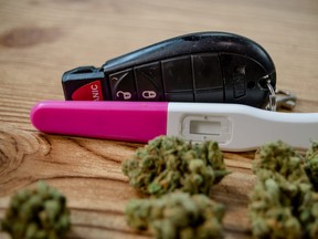 In this stock photo, car keys, a pregnancy test and cannabis sit on a table.