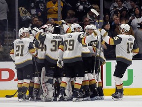 Vegas Golden Knights players celebrate after defeating the Los Angeles Kings 1-0, and sweeping the series in Game 4 of an NHL hockey first-round playoff series in Los Angeles, Tuesday, April 17, 2018. (AP Photo/Alex Gallardo) ORG XMIT: LAS115