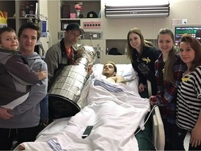 Ryan Straschnitzki, centre, poses with brothers Connor, left to right, and Jett, father Tom, girlfriend Erica, sister Jaden and mother Michelle as they pose with the Stanley Cup at Royal University Hospital in Saskatoon in this recent handout photo. The Stanley Cup has visited the hospital bedsides of Humboldt Broncos who survived a deadly bus crash.