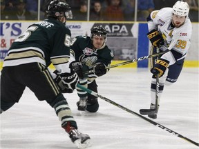 Spruce Grove Saints' Austin Parmiter (39) battles Okotoks Oilers Ryan Roberts (3) during the first period of Game 4 of the AJHL finals at Grant Fuhr Arena in Spruce Grove on April 17, 2018.