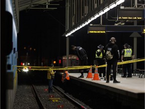 Investigators are seen at Belvedere LRT Station in Edmonton, on Wednesday, April 25, 2018. after a man's leg was nearly severed when he kicked an LRT train, according to police.