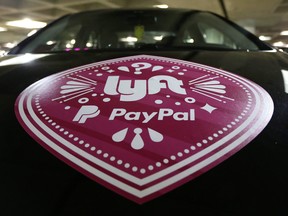 A vehicle with the logo from the Lyft ride sharing service is shown at Seattle-Tacoma International Airport, Thursday, March 31, 2016 in Seattle. THE CANADIAN PRESS/AP-Ted S. Warren