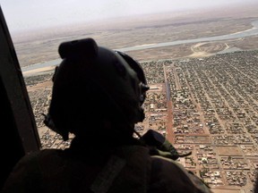 A French soldier stands inside a military helicopter during a visit by French President Emmanuel Macron to the troops of Operation Barkhane, France's largest overseas military operation, in Gao, northern Mali, Friday, May 19, 2017. THE CANADIAN PRESS/AP-Christophe Petit Tesson, POOL