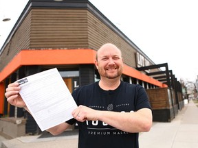 Jeff Mooij, President and CEO of 420 Investments, poses with a blank applicaion outside a proposed location northwest Calgary on Tuesday, April 24, 2018. The City of Calgary started accepting applications for cannabis retail stores both in person and online on Tuesday morning. Jim Wells/Postmedia