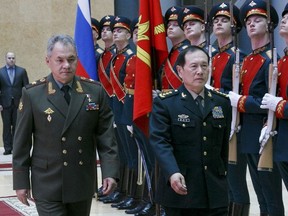 Russian Defense Minister Sergei Shoigu, left, and China's Defense Minister Wei Fenghe review an honour guard prior to their talks in Moscow, Russia, Tuesday, April 3, 2018.