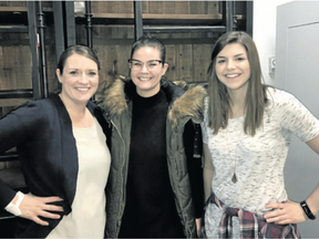 Homes by Avi’s Julie Punter, left, and Jenn Madsen, right, stand with Stampede Dream Home Artist winner Tiffany Cuffley.