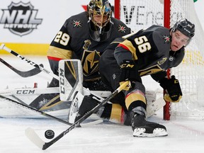 Vegas Golden Knights left wing Erik Haula knocks the puck away from goaltender Marc-Andre Fleury during an NHL game against the Colorado Avalanche on March 26, 2018