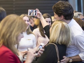 Prime Minister Justin Trudeau poses for a selfie at the Rotman Initiative in Business International Women's Day event in Toronto on Wednesday March 7, 2018.