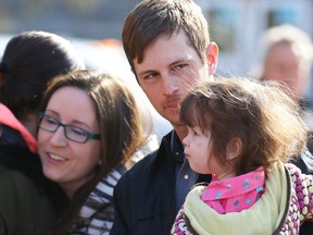 Edouard Maurice, outside Okotoks court, with family, daughter, Teal and wife, Jessie, the local landowner is facing three charges of aggravated assault, pointing a firearm and careless use of a firearm, following a robbery at his home on Tuesday, February 24. Al Charest/Postmedia