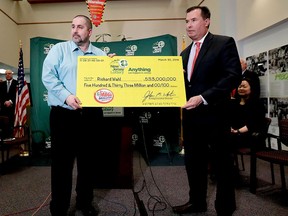 Richard Wahl, left, poses for photos with John White, New Jersey Lottery Acting Executive Director, during a news conference introducing Wahl as the $533 million Mega Millions jackpot winner at the New Jersey Lottery headquarters, Friday, April 13, 2018, in Trenton, N.J. Wahl hit the winning numbers during the Friday, March 30 drawing on a ticket he bought at a gas station in Riverdale, N.J. (AP Photo/Julio Cortez)