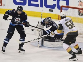 Connor Hellebuyck #37 of the Winnipeg Jets makes a save during the third period against the Vegas Golden Knights in Game Five of the Western Conference Finals during the 2018 NHL Stanley Cup Playoffs at Bell MTS Place on May 20, 2018 in Winnipeg, Canada.