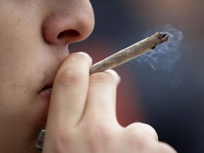 A man smokes a joint during a demonstration for the decriminalization of cannabis in France, in Paris on May 12, 2018. Some 1,300 people, according to the police, marched today in Paris for the decriminalization of cannabis in France, which "remains blocked" while, for the organizers, "the other countries have never advanced so far" on this issue.