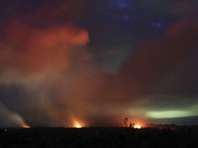 Lava shoots into the night sky from active fissures on the lower east rift of the Kilauea volcano, Tuesday, May 15, 2018 near Pahoa, Hawaii.