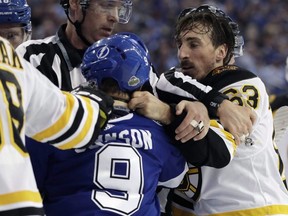 Bruins left wing Brad Marchand (right) and Lightning centre Tyler Johnson (9) scrap during NHL playoff action in Tampa, Fla., Monday, April 30, 2018