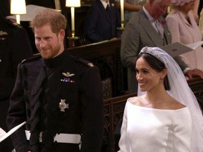 In this frame from video, Britain's Prince Harry and Meghan Markle stand during their wedding ceremony at St. George's Chapel in Windsor Castle in Windsor, near London, England, Saturday, May 19, 2018. (UK Pool/Sky News via AP) ORG XMIT: NYAG106