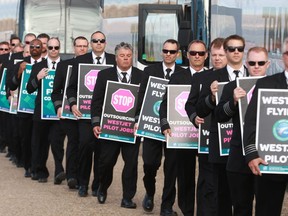 About 150 WestJet pilots protest outside the company's headquarters in Calgary during the WestJet annual general meeting on May 8, 2018.