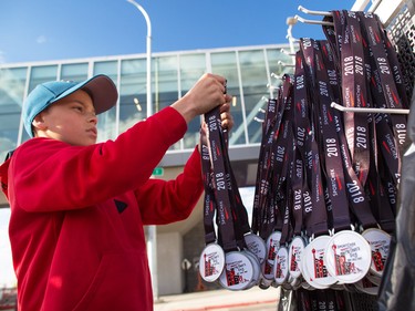 Volunteers ready finisher medals for about 6000 runners, walkers and riders in the annual Sport Chek Mother's Day Run and Walk at Chinook Centre on Sunday May 13, 2018. The event is a fundraiser for the neonatal intensive care units in Calgary.