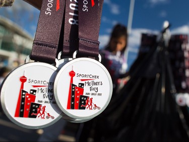 Volunteers ready finisher medals for about 6000 runners, walkers and riders in the annual Sport Chek Mother's Day Run and Walk at Chinook Centre on Sunday May 13, 2018. The event is a fundraiser for the neonatal intensive care units in Calgary.