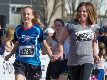Mom Clare Davis and daughter Kate cross the 5 km finish line together in the Sport Chek Mother's Day Run Walk and Ride at Chinook Centre on Sunday May 13, 2018. The event is a fundraiser for the neonatal intensive care units in Calgary.