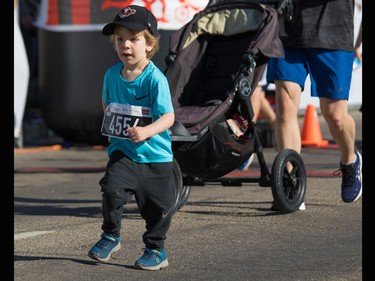Young Keenan Peters crosses the 5 km finish line in the Sport Chek Mother's Day Run Walk and Ride at Chinook Centre on Sunday May 13, 2018. The event is a fundraiser for the neonatal intensive care units in Calgary.