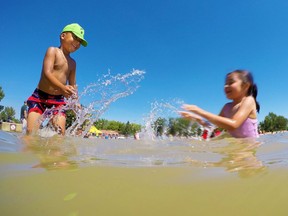 Kyrie Tillett, 6 and Gisele Fernandez, 5, have fun splashing in Sikome Lake on a hot Wednesday afternoon July 26, 2017. The lake is having a much busier year after last summer's wet cool weather. Gavin Young/Postmedia Gavin Young, Gavin Young