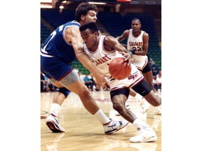 Calgary 88's guard Andre Turner tries to dribble around Illinois forward Marty Simmons. Photo taken August 20, 1988. Postmedia Archives